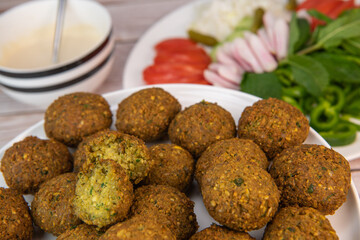 Fried falafel balls and tahini sauce with chopped legumes and chickpeas. High quality photo