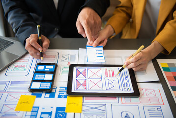  UX developer and ui designer brainstorming about mobile app interface wireframe design with...