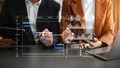 Businessman hand Project manager working and update tasks and Gantt chart scheduling virtual diagram.with smart phone, tablet