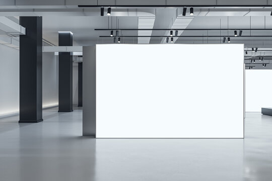 Front view on white blank partition with space for advertising poster or picture frame or campaign in abstract exhibition hall with concrete floor and black pillars on background. 3D rendering, mockup