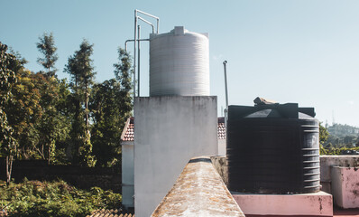 Overhead water tanks on the roofs for storing the water needs for the house.