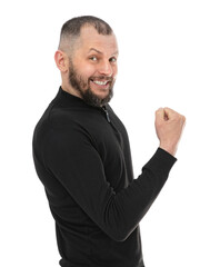 Portrait of thirty year old man celebrating surprised and amazed for success, isolated on white background. Bearde caucasian man in blackturtleneck clenching fist and posing in studio.