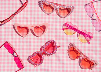 Summer creative layout with heart sunglasses on pastel pink plaid  background. 80s or 90s retro...