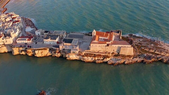 4k drone flight moving to the side footage (Ultra High Definition) of Vieste - coastal town in Gargano National Park with Castello Svevo, Italy, Europe. Bright spring scene of Adriatic sea.