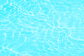 Blue water with ripples on the surface. Defocus blurred transparent blue colored clear calm water surface texture with splashes and bubbles. Water waves with shining pattern texture background.