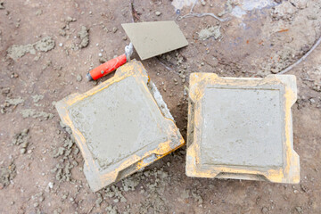 Concrete cube molds for compressive strength test of the cement mixture - obrazy, fototapety, plakaty