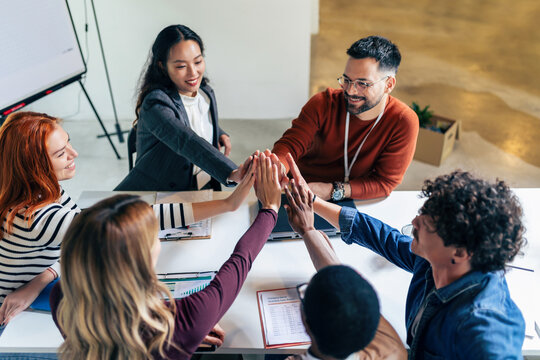 Business team showing unity with their hands together.