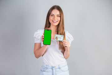 Blond Brazilian woman holding RG, Identity Card and smartphone. Translation in English (National...
