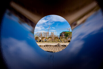Look through stone pipes with resistant glaze placed on the ground in front construction site
