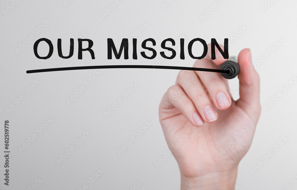 Wall mural womans hand writing word our mission with marker