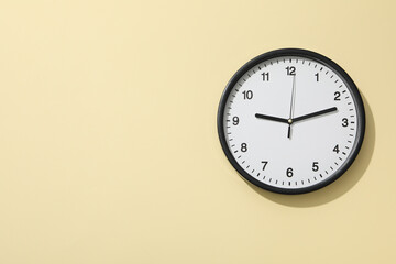 Concept of time change with clock on beige background