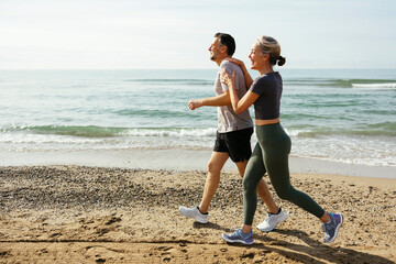 Happy couple running and having fun at beach