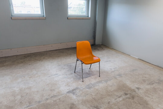 Orange color chair in empty room