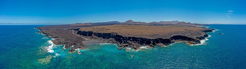 Fototapeta na wymiar Drone panorama of volcanic coast near El Golfo on Lanzarote with Playa del Paso during daytime