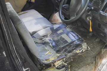 Interior of old car seat is badly damaged and broken full of tape patches. Black colored car seats...