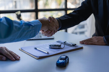 successful handshake and agreement Car dealers and customers celebrate contract completion after signing insurance and investment loans. car sale concept