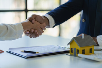Successful handshake and agreement Real estate agent and client celebrating contracts completed after signing on home insurance and investment loans. house sale ideas