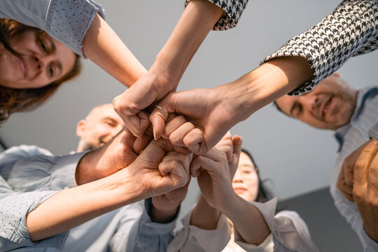 Business people putting their fists together