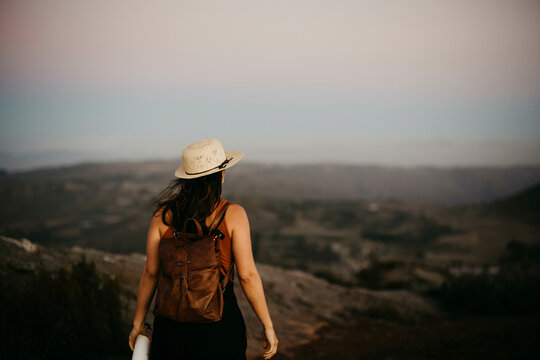Woman with backpack looking at mountain