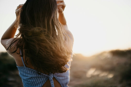 Woman with long hair at sunset