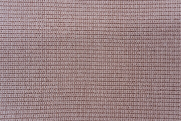 Knitted fabric texture. Close up of a woolen knitted fabric
