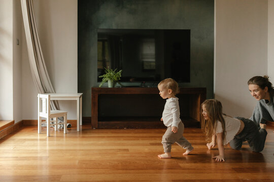 Family playing on hardwood floor at home