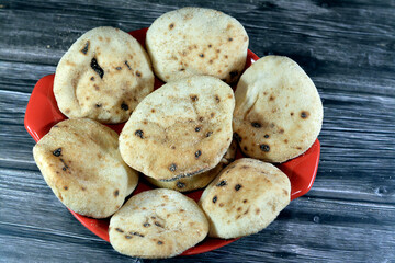 Mini traditional Egyptian flat bread with wheat bran and flour, small Aish Baladi or small bread baked in extremely hot ovens, it is the result of a mixture of wheat flour, yeast, salt and water - obrazy, fototapety, plakaty