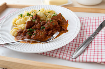 Goulash with pasta on a plate