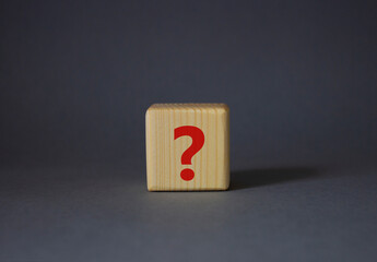 Question mark symbol. Concept words question mark on wooden cube. Beautiful grey background....