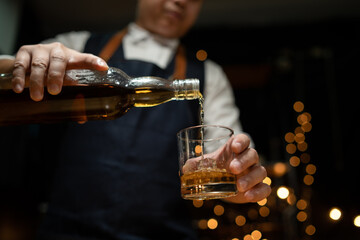 Barman pouring whiskey whiskey glass beautiful night