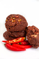 chili and chocolate biscuits or cookies on gray with fresh chili peppers