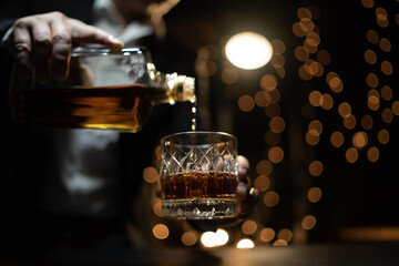 Barman pouring whiskey whiskey glass beautiful night