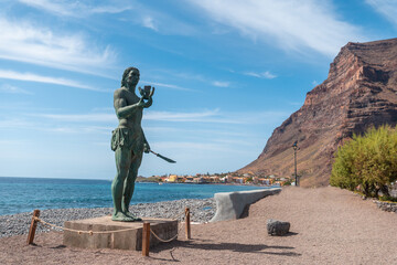 Precious statue of Hautacuperche on the beach of Valle Gran Rey village in La Gomera, Canary Islands