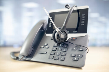 Headset headphones and telephone in call center office concept for communication, contact us and...