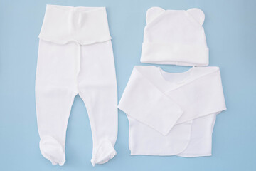 suit for a newborn on a blue background. Waiting for the boy. Clothes for newborns
