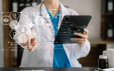 Doctor work on digital tablet healthcare doctor technology tablet using computer in a modern office  in the morning at the desk.