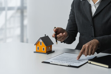Real estate, insurance, loan, leasing agents are explaining house designs and details in sales contracts to customers who come to see the house and make a deal inside the office.