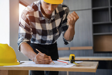 Male designer in office working on architects project.