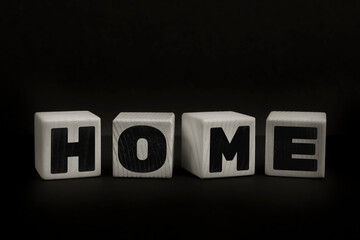 Obraz premium Word HOME written with wooden cubes. Studio shot of some arranged wooden blocks with a testual message.