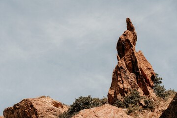 A close up of rocks that look like the beak of a bird or a sharp nose The picturesque volcanic coast of the island on the ocean waters - sharp rocks, dark stones