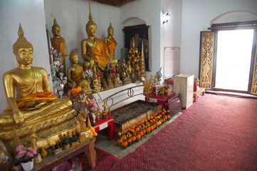 Group of golden sitting Buddha images in the Buddhist Church of Wat Phra That Phousi at Phu Si Hill is the view point of central Luang Prabang city in Northern of Laos.