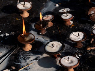 Horizontal view of butter lamps as buddhist offerings in Swambunath stupa, Nepal.