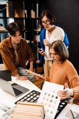 Fototapeta premium Group of architects choosing materials for interior design project in office