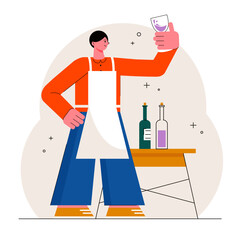 Taster standing in factory near table with wine bottles, holding glass of wine and checking color