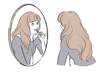 鏡を覗き込み口紅を塗る女性