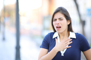 Stressed woman choking in the street