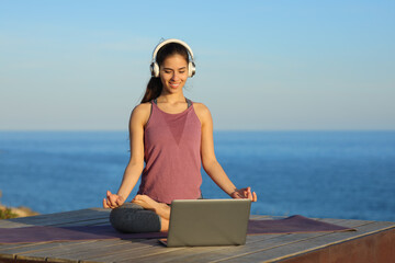 Yogi doing yoga watching video tutorial online