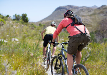 Fototapeta na wymiar mountain bikers on dirt path