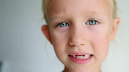 Portrait of a preschool girl with an open mouth without upper milk teeth