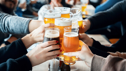 A group of people clinking glasses with beer